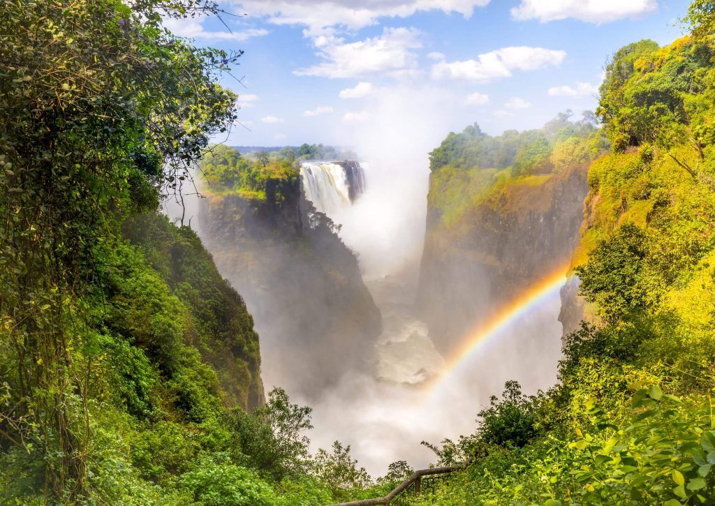 Sightseeing Victoria Falls in Zambia with rainbow while on an exclusive, luxury safari with Premier Africa
