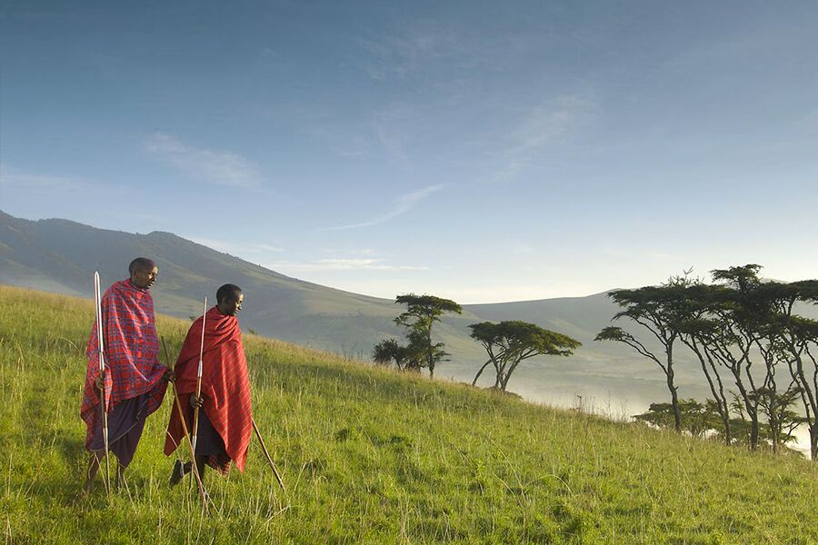 Locals walking in landscape with a private tour group in Tanzania