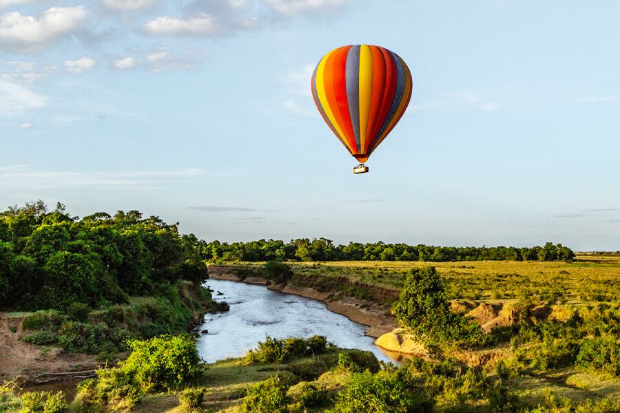 Wildlife viewing over river from hot air balloon while on a luxury safari in East Africa.