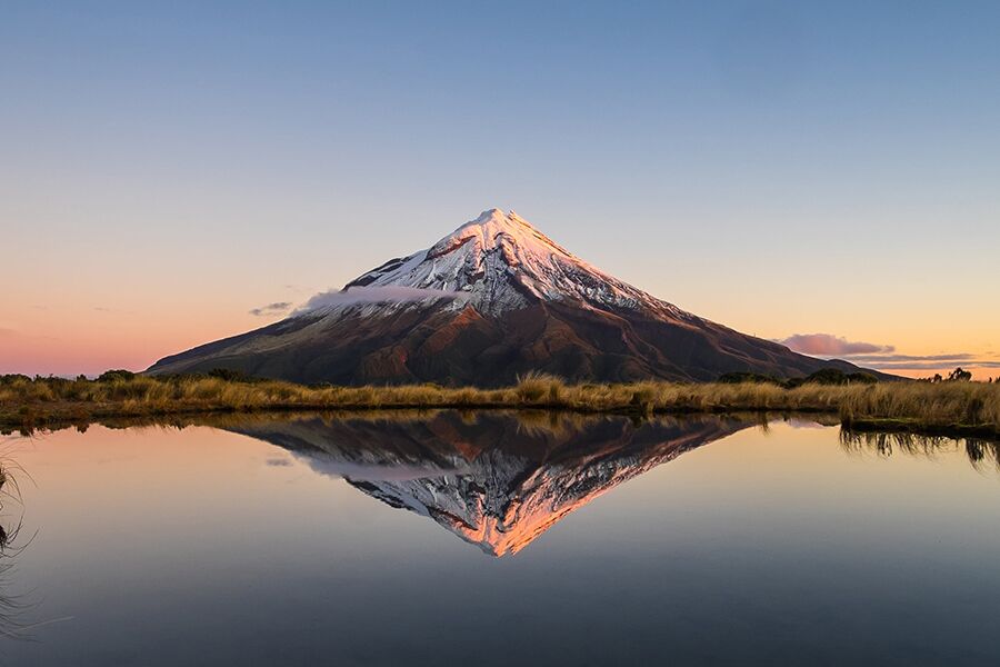 Stunning view of a snow peaked Kilimanjaro across a lake while on a luxury safari tour